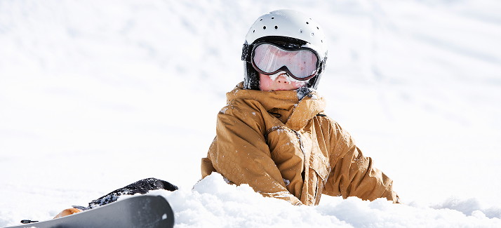 kindje met skies in de sneeuw
