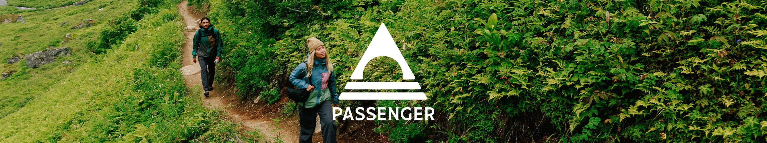Wandelaars op een groen bergpad met het Passenger-logo